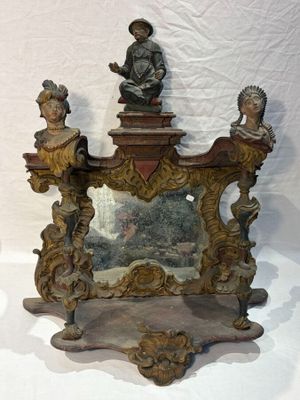 a mirror with a statue on top of it