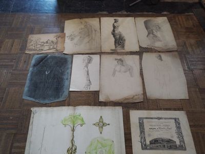 many old books on the floor with drawings on them