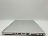 a close up of a laptop computer on a white surface