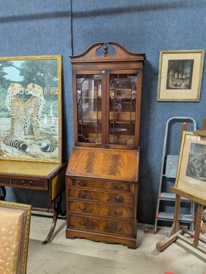 a lot of antique furniture in a room with blue walls