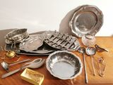a wooden table with a lot of silverware on it