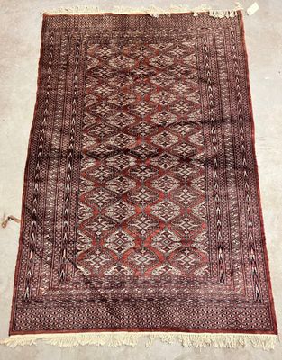 a red and brown rug with a diamond design on it