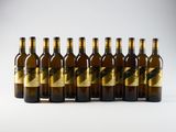 six bottles of beer lined up in a row on a white surface