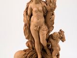 statue of a woman with a dog and a bird on a rock