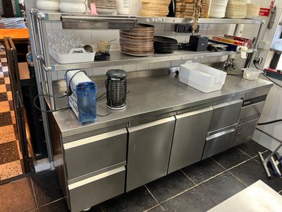 a large kitchen with a lot of dishes on the counter