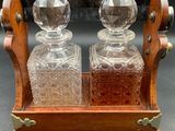 an image of a pair of glass decanters on a wooden stand