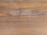a close up of a wooden table with a knife and fork on it