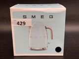 a box with a tea kettle on it on a table