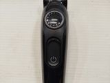 a close up of a black electric shaver on a table