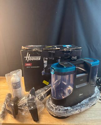 a black and blue blender sitting on a wooden table
