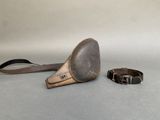 a small metal object that is next to a belt