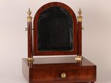an antique wooden vanity mirror with a mirror on top of it