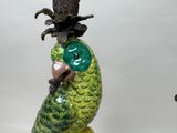 a figurine of a parrot with a pineapple on its head