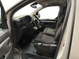 the interior of a car with the door open and the driver ' s seat down