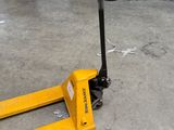 a fork lifter sitting on the floor in a warehouse