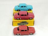 several toy cars are lined up in a row on a white surface