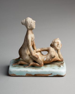 figurine of a woman and a child on a marble base