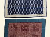 two pieces of cloth with squares and dots on them on a white background