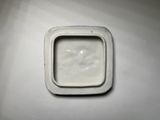 a small square white container on a white surface