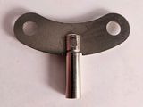 a small metal object on a white surface