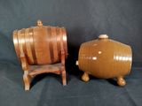 pair of wooden barrel chairs and a wooden barrel on a black background
