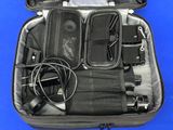 an open suitcase with electronics in it on a blue surface