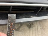 someone is measuring the height of a car with a ruler