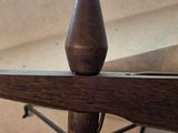 a close up view of the top of a chair with a wooden seat