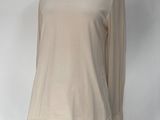 beige long sleeved top on a mannequin base
