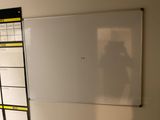 someone is taking a picture of a white board in a room