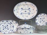 a lot of plates and bowls that are sitting on a table