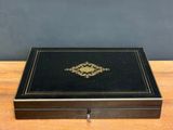 a black and gold box on a wooden table
