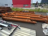 many pieces of metal on the ground in front of a building