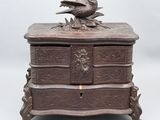 an old wooden box with a bird on top of it