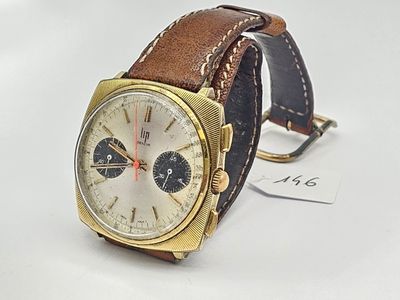 a watch that is sitting on a white surface