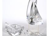 a glass ashtray and a glass ashtray on a table