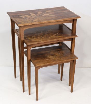 three wooden nesting tables with a shelf on top of them