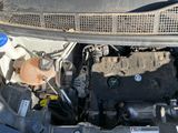 a close up of a car ' s engine with its hood open