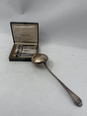a silver spoon and a silver spoon in a box