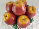 apples in a basket on a table with a white table cloth