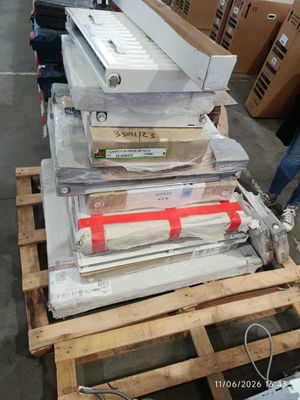 a stack of boxes and boxes on a pallet in a warehouse