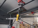 a crane that is hanging from the ceiling in a garage