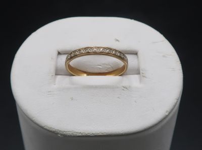 a close up of a gold ring with diamonds on it
