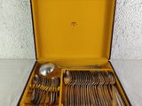a lot of silverware in a case on a table