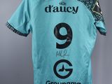 a shirt with the number 9 on it hanging from a hanger