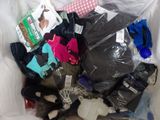 a pile of clothes and shoes in a plastic bag