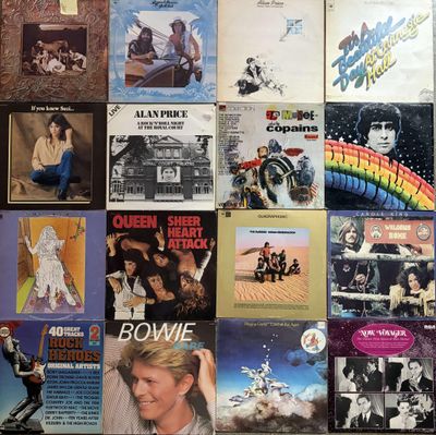 many different album covers on the wall of this room