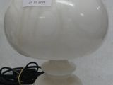 a white lamp that is sitting on a table