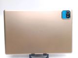 the back of a gold laptop computer sitting on top of a white surface