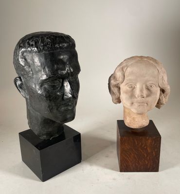 deux sculptures représentant une tête d'homme et une tête de femme
